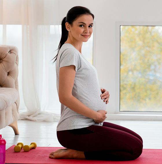Woman seated on yoga mat