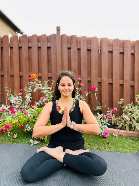 Woman seated on yoga mat