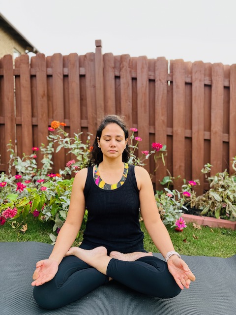 Woman seated on yoga mat