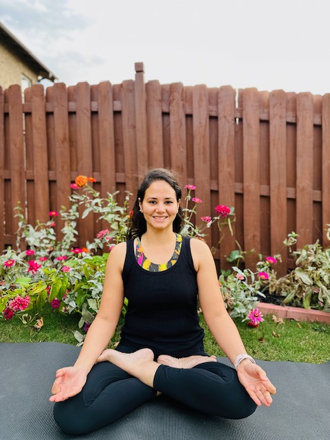 Woman seated on yoga mat
