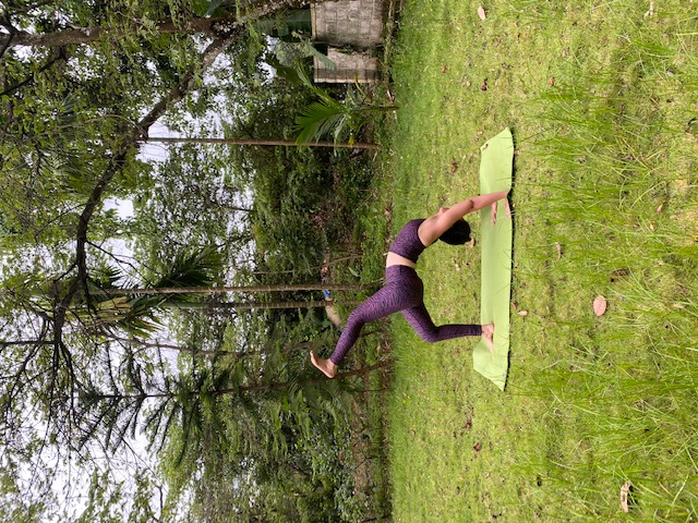 Woman seated on yoga mat