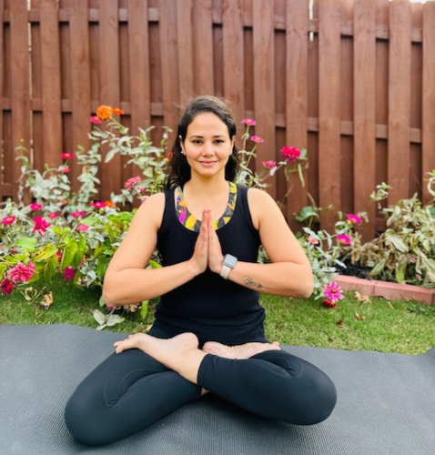 Woman seated on yoga mat